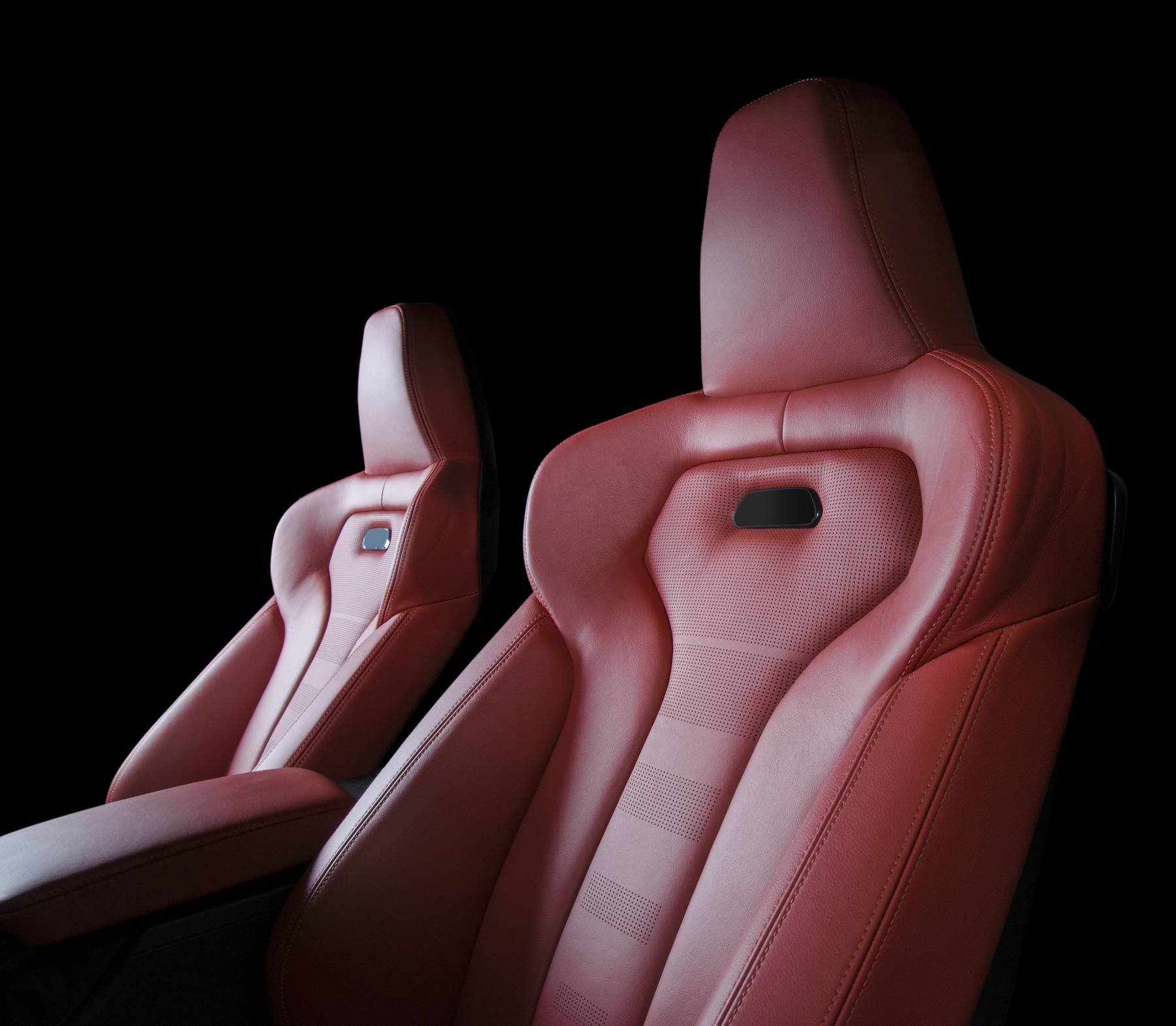 Red leather car seats isolated on black background